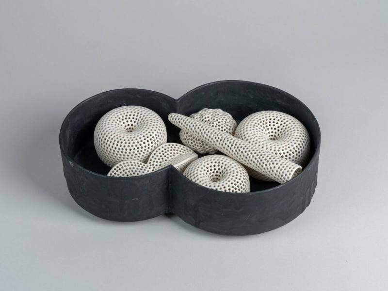 Black Vessel with Pierced White Forms