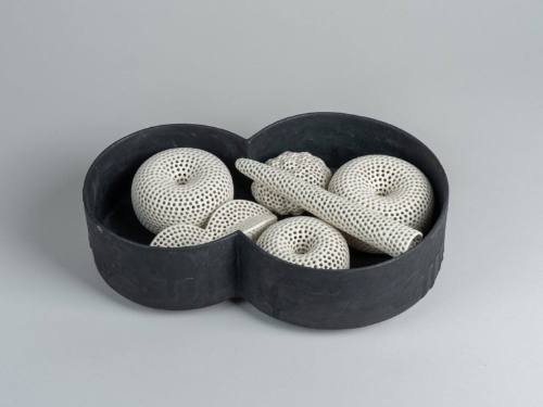 Black Vessel with Pierced White Forms